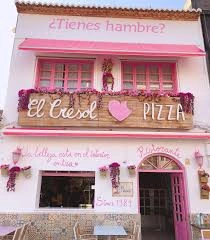 The pink façade of El Cresol in Oliva Beach